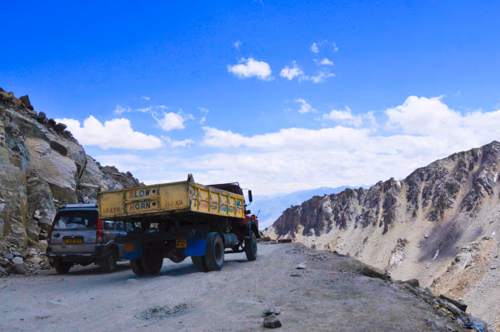 Heavy vehicles driving over Khardung La, the highest road in the world