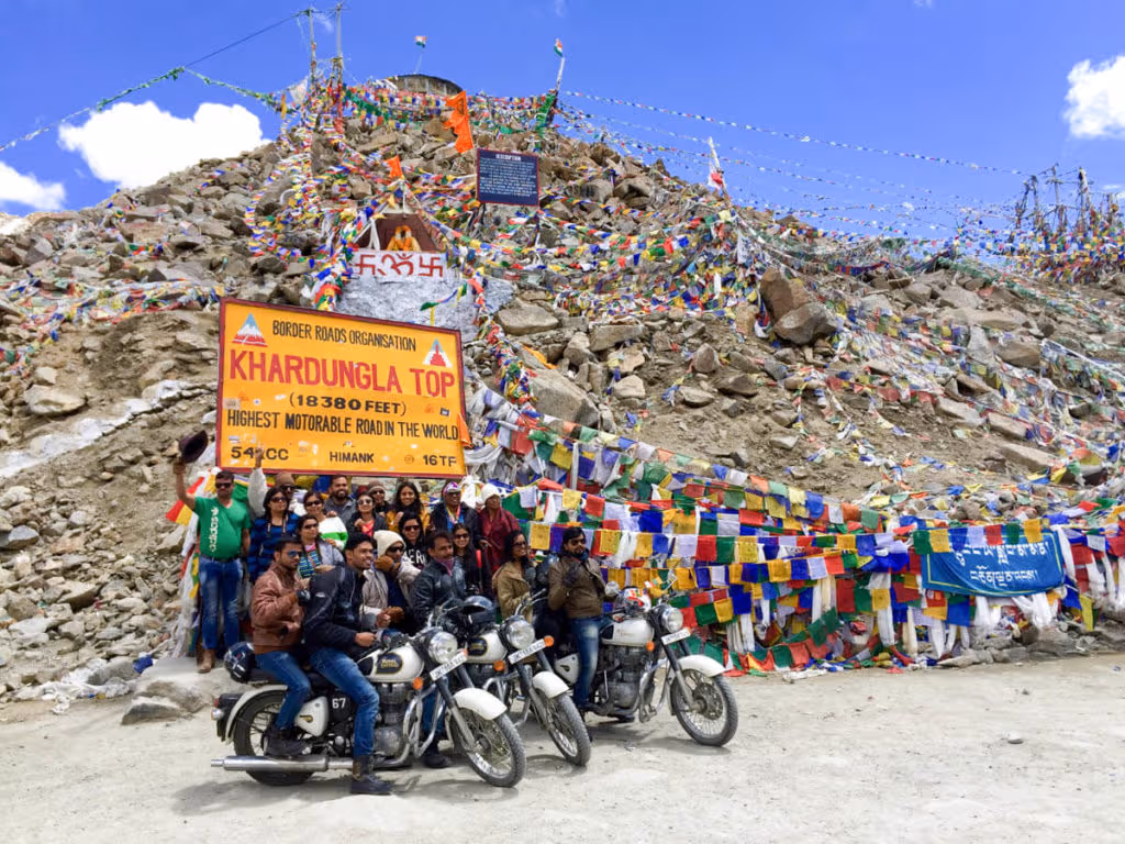 Tourists Indians taking a group picture in the highest road in the world, Khardung La, Ladakh