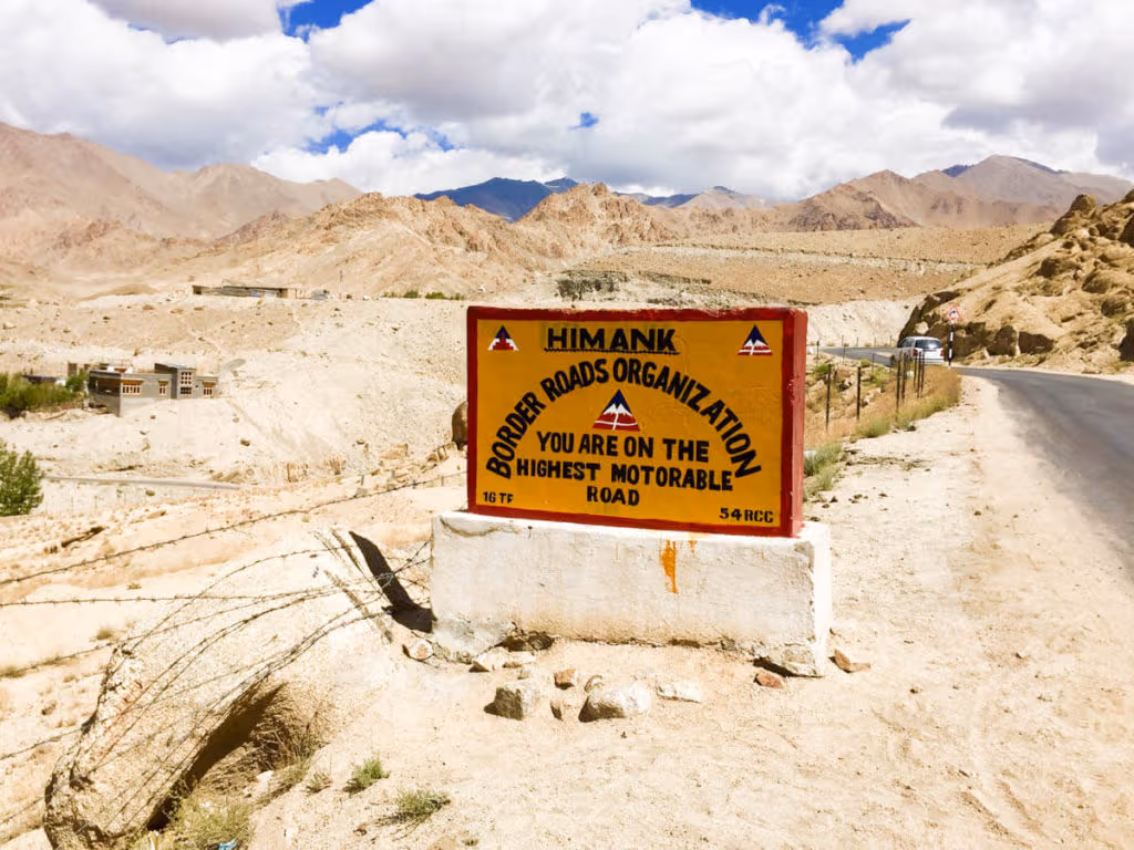 Road sign announcing that you are on the highest motorable road in the world
