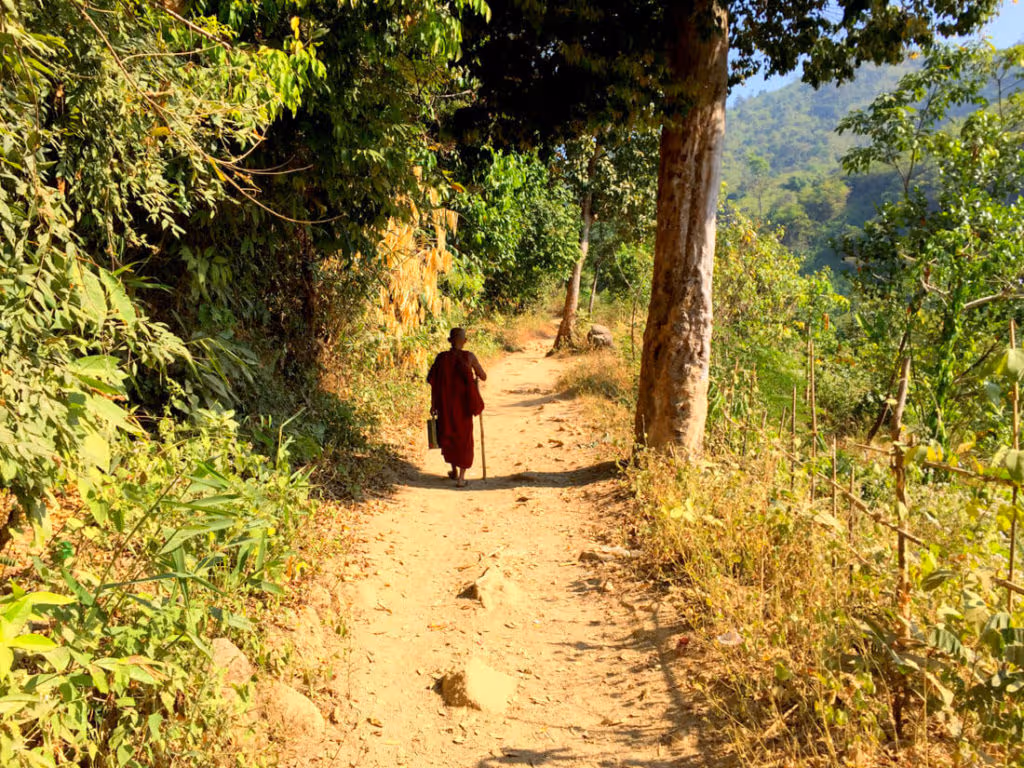 Buddhist pilgrim walking up to Kyaktiyo pagoda, Golden Rock