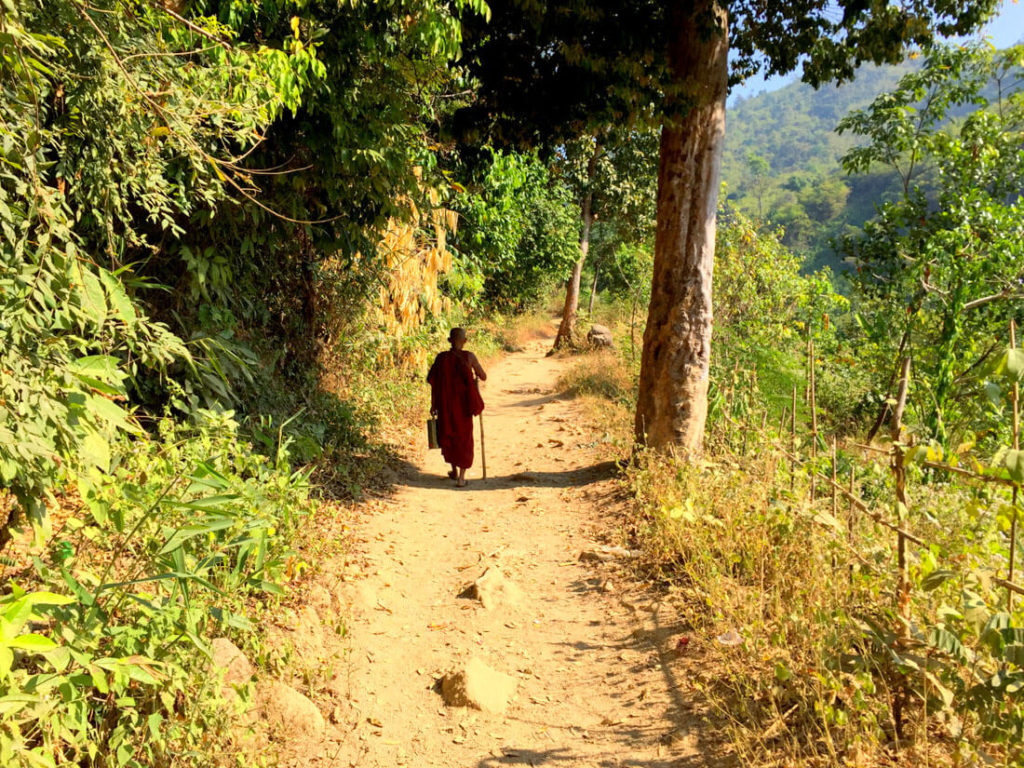 Buddhist pilgrim walking up to Kyaktiyo pagoda, Golden Rock