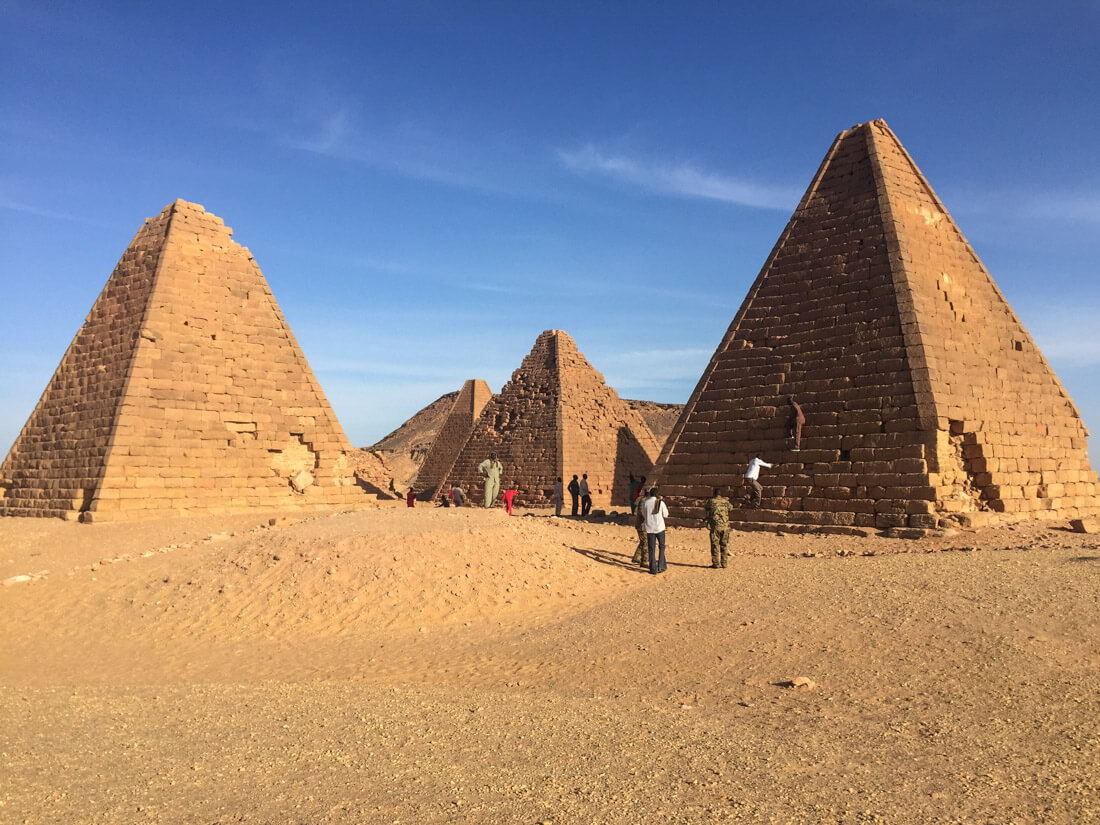 The pyramids of Jebel Barkal and some locals climbing them, Karima