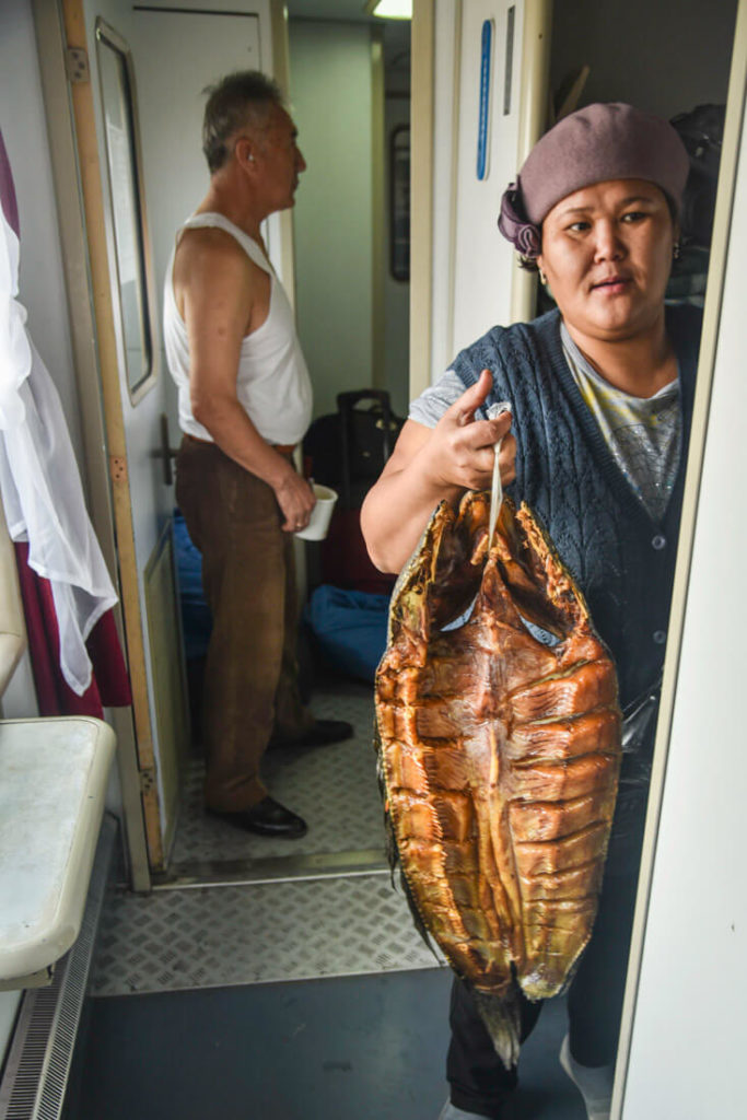 Woman selling fish in Kazakh train 