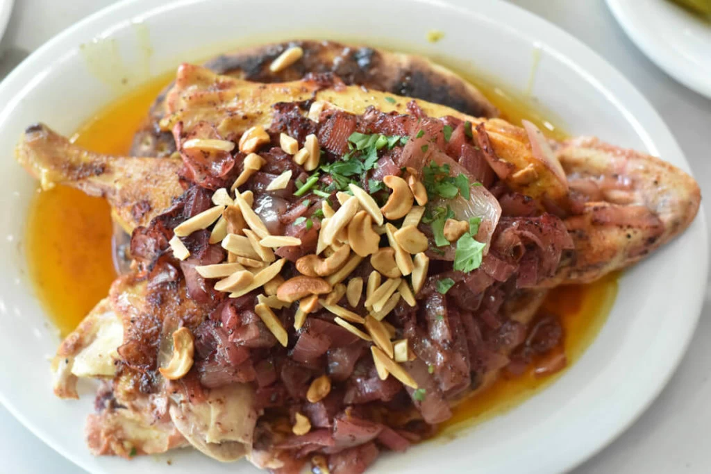 Palestine Msakhan, consisting of roasted chicken on a thick slice of bread and covered with onions and chestnuts